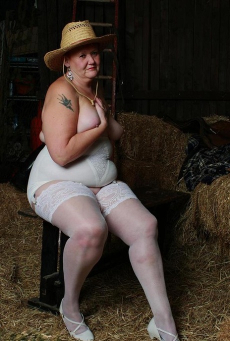 Valgasmic Exposed, an older redhead who is in a barn, exhibits her tits and twat.