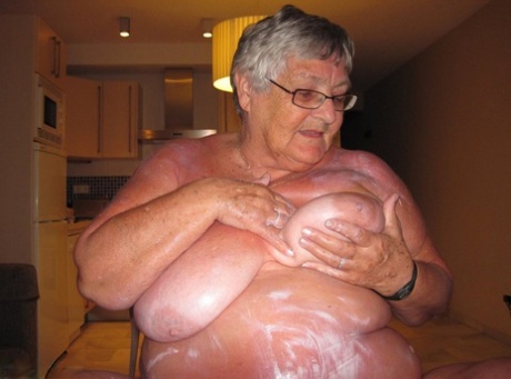 Grossman Libby, an elderly woman who is mentally unstable and emotionally unstable (she was in heaven), covers herself with lotion while lying naked.