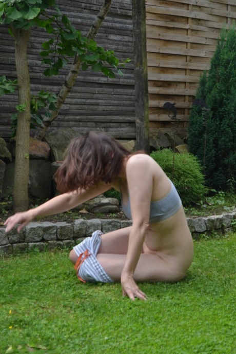 On the back lawn, an amateur model bares her skin before taking on weights and testing the backward crab.