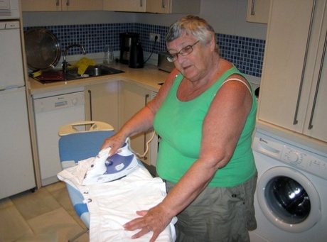 Ironing: Overweight British oma Grandma Libby shows off her breasts.