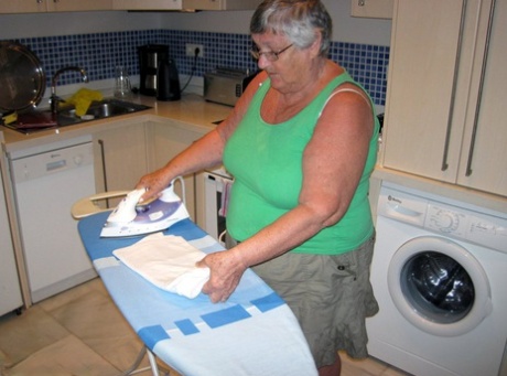 In her ironing, overweight British oma Grandma Libby displays her breasts as she gets dressed.