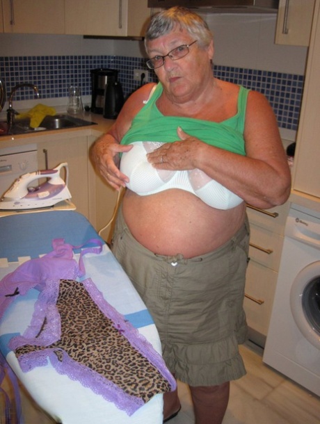 An overweight British woman named Grandma Libby displays her breasts while ironing.