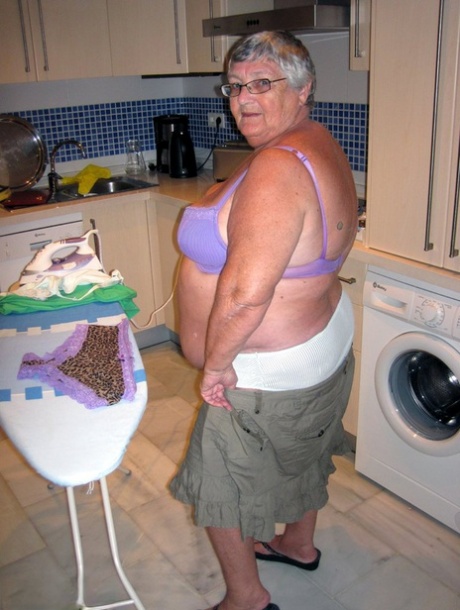 When ironing, Grandma Libby (an obese British mom) exposes her breasts.