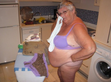 Exposed: Grandma Libby, an overweight woman from Britain who is also known as "Oma," shows off her breasts while ironing.