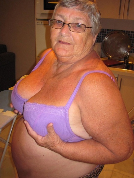 While ironing, overweight grandmother Grandma Libby can be seen flaunting her chest.