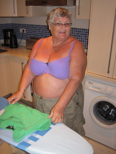 As she irons her chest, Grandma Libby, an obese British woman, displays her breast tissue.
