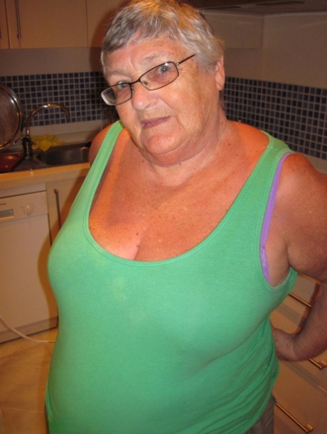 During her ironing session, Grandma Libby, a heavyset British woman, displays the excess fat she has shed.