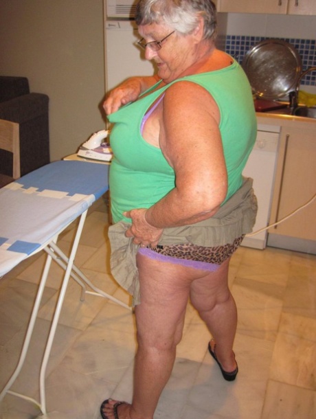 Overweight: British oma Grandma Libby shows off her breasts while ironing.