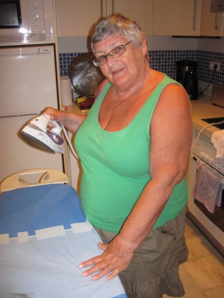 Big sister Grandma Libby, who is overweight and has never ironed before in history, shows off her chest with a pair of scissors.
