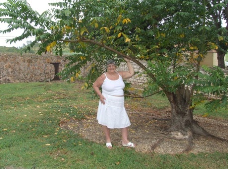 Old British woman, Grandma Libby, exposes her massive breasts beneath a tree.