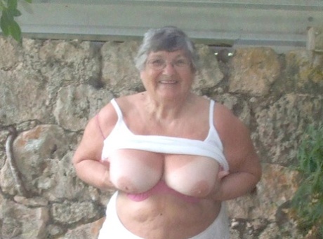 Big tits: Obsed British woman Grandma Libby shows her large breasts beneath a tree.