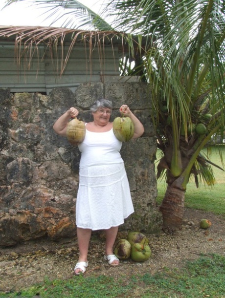 Exposed grandmother, a mentally unstable British woman known as Grandma Libby, exposes her large breasts beneath a tree.