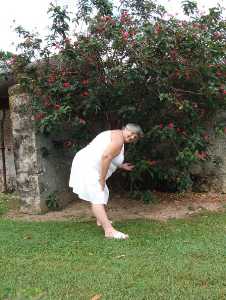 Under a tree, Grandma Libby (an old woman from Britain) exposes her large breasts as she ages.