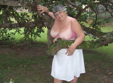 Obese British lady Grandma Libby exposes her large tits underneath a tree