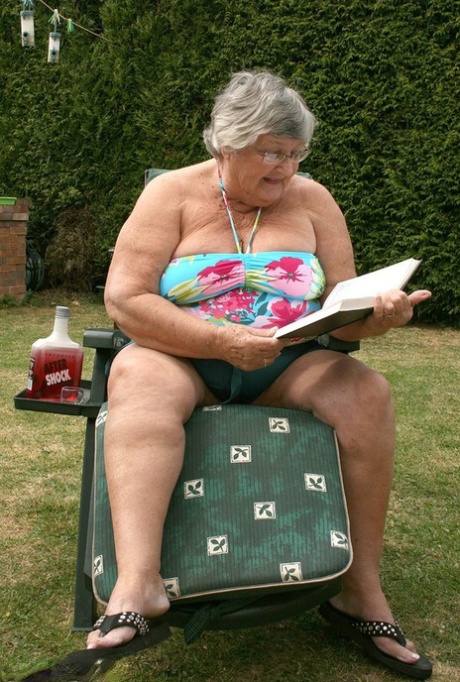 In the garden, naughty granny Libby was inserting a bottle into her large pussy.