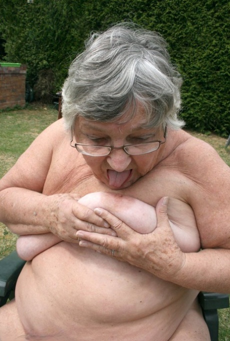 Granny Libby, an unfeeling inexperienced individual, placing a bottle in her large vagina while gardening.