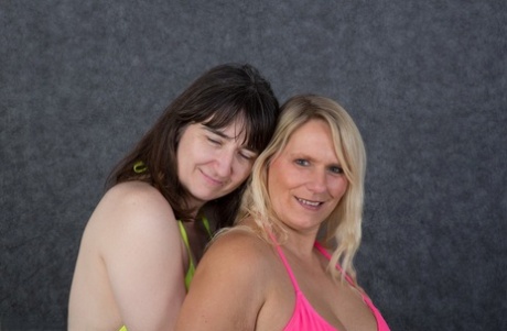A woman who is a blonde amateur named Sweet Susi and her lesbian partner remove their bikinis.