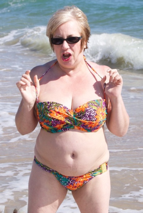 Snub: British woman of 50s Speedy Bee gets naked at the beach while wearing sunglasses.