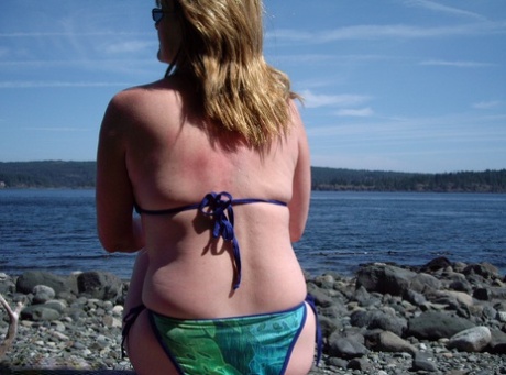 A middle-aged Cougar named Babe Lolee takes off her swimsuit on a rough beach.