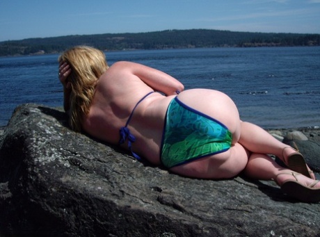 Cougar Babe Lolee, who is middle aged and not a professional, removes her swimsuit on a rough beach.