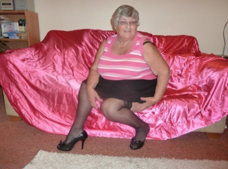 Obsese Grandmother Holds Her Fat Rolls While Stripping To Black Stockings