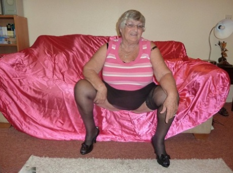 Obsese Grandmother Holds Her Fat Rolls While Stripping To Black Stockings
