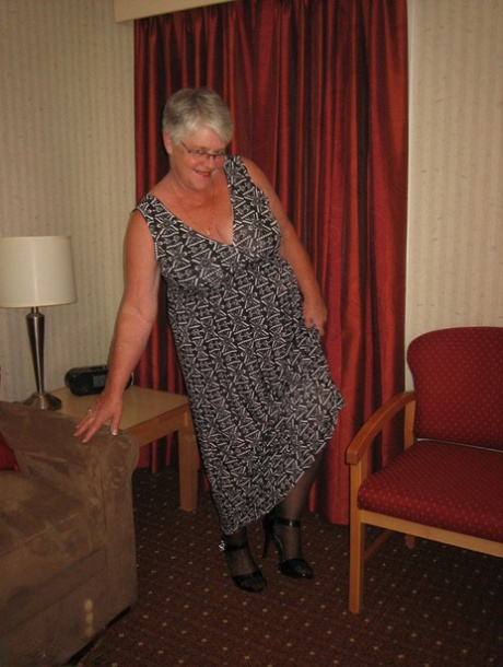 A fat granny Girdle Goddess wears a black slip and girdle with her no panty upskirt.