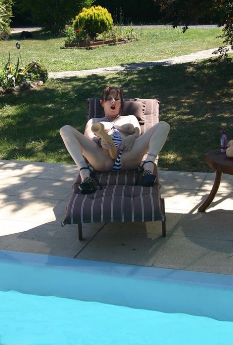 Busty Mature Woman Mary Bitch Sticks A Massive Dildo In Her Cunt By A Pool