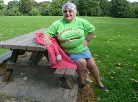 Obese oma Grandma Libby exposes her large breasts and buttocks on a picnic table.