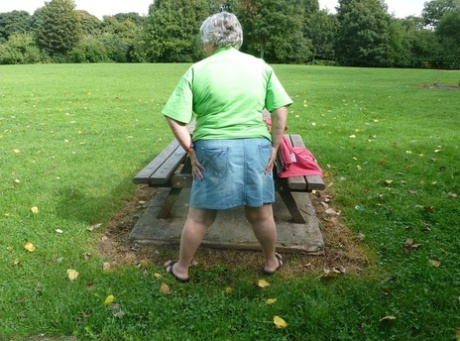 Grandma Libby, who is an elderly woman, exposes her large tits and buttocks on a picnic table.