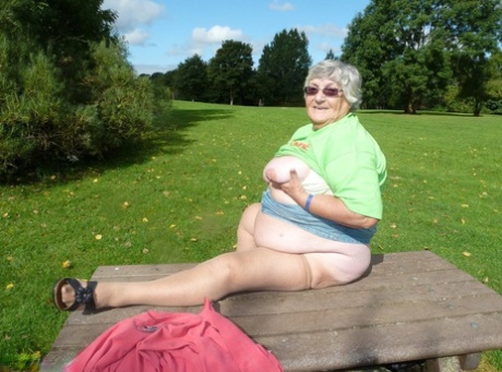 Older woman: Obese grandmother Libby lies on her picnic table to show off the large portions of her torso and buttocks.