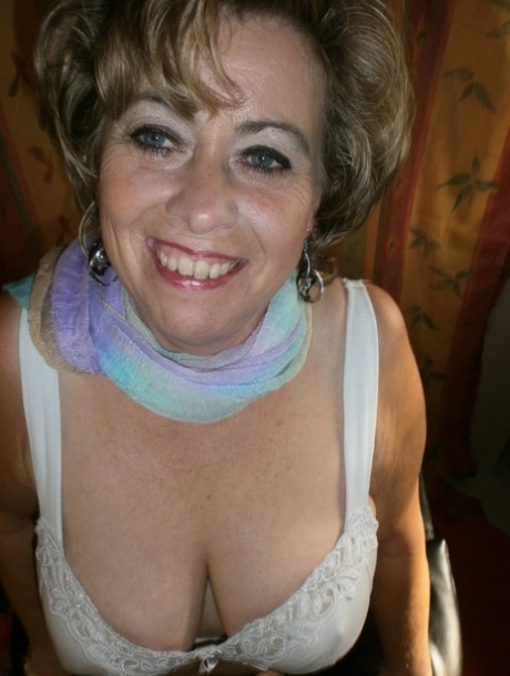 Mature amateur Caro uncups her large boobs wearing hose over top of underwear