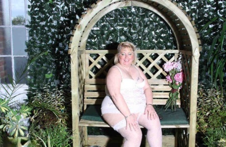 In a garden, Lexie Cummings gets her pussy in the form of a dildo, while she is fat and blonde.