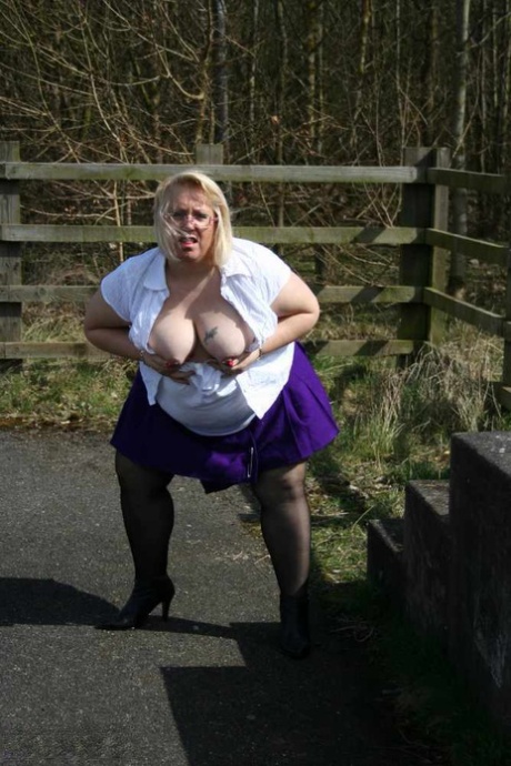 The obese British amateur, Lexie Cummings, licks her penis before crossing the footbridge.