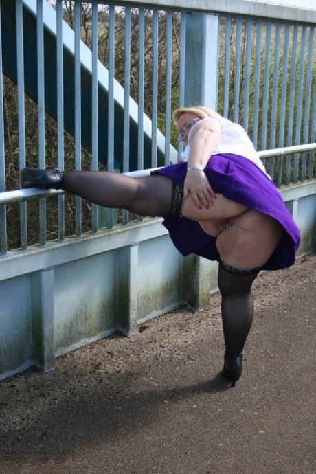 Prior to crossing a footbridge, Lexie Cummings, an obese British amateur player, releases her penis and takes another puff.