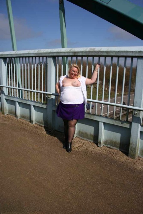 Lexie Cummings, an unqualified British amateur, licks her penis before crossing a footbridge.