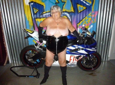 Grandma Libby, an elderly woman with a high body fat, sews up black boots on a motorcycle.