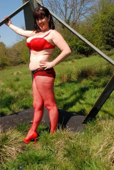 UK amateur Juicey Janet bares his legs on the heels beneath a hydro tower.