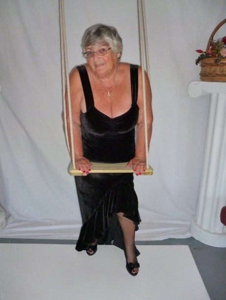 Taking off her black dress and modeling in stockings, Grandma Libby looks fat.