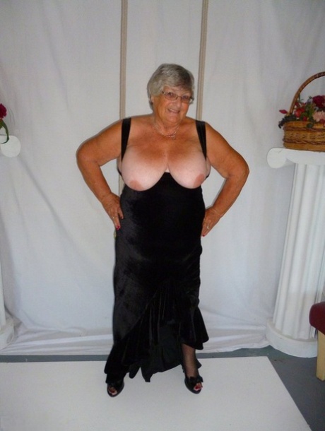 In stockings, Grandma Libby models herself in a black dress.