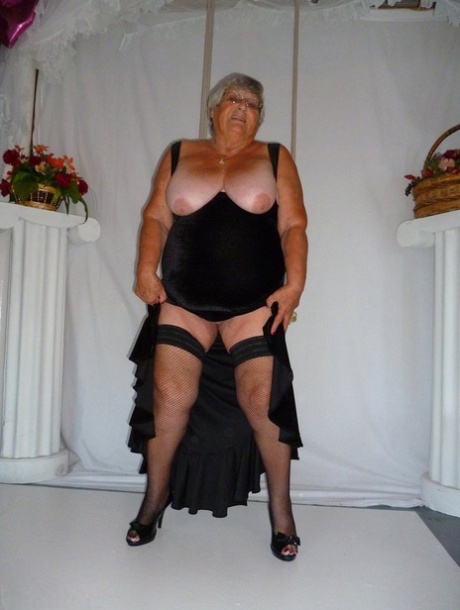 Fat grandmother Grandma Libby models herself in stockings wearing only black dresses.