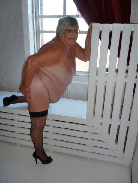 Fat nan Grandma Libby takes off a black dress to model naked in stockings