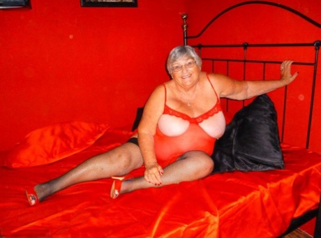 Older woman, Grandma Libby (of Obese Nannie), uses a bath to dildo her freshly shaved vagina on a bed.
