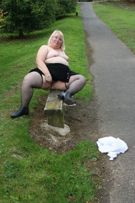 Lexie Cummings, the feisty anata female, flaunts her breast tissue and ample penis on a park bench.
