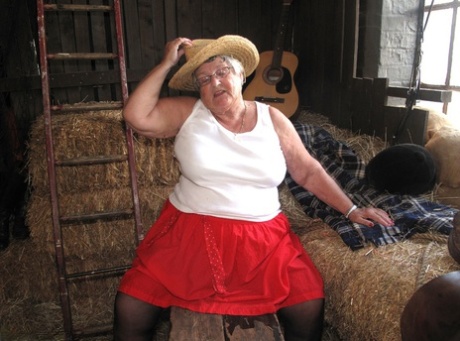 Old grandmother, Grandma Libby (of British bloodline), gets naked on the stockings of a straw bed.