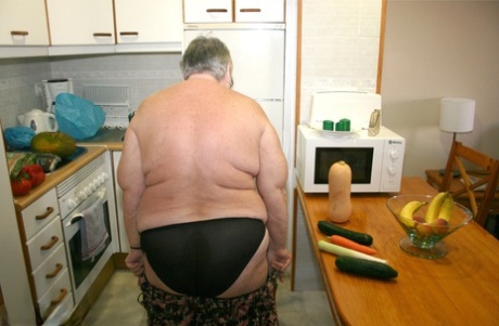 Grandma Libby, an obese British woman, is stripped down while playing with vegetables.
