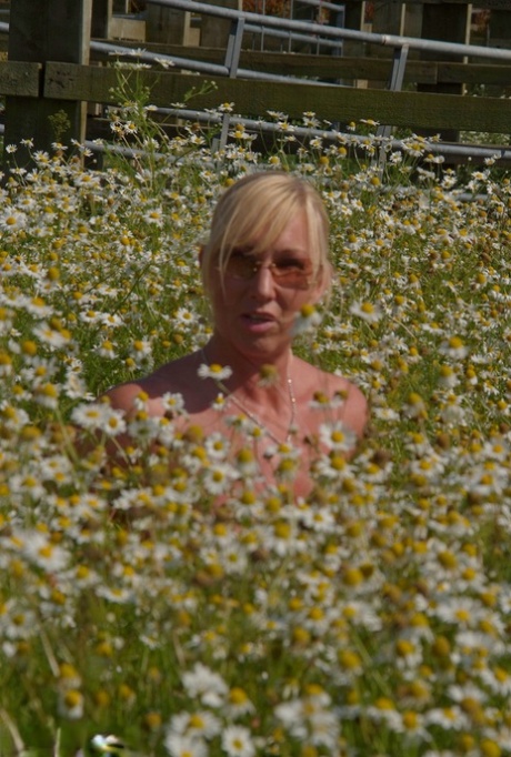 A field of wild flowers is where Melody, a heavy-settled blonde, unclogs her large breasts with her massive chest.