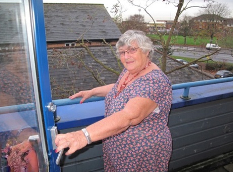 Fat UK nan Grandma Libby exposes herself on a balcony before getting naked.