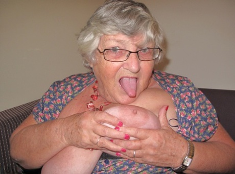 Exposed on a balcony, Grandma Libby from the Fat UK shows off her breasts before getting nude.