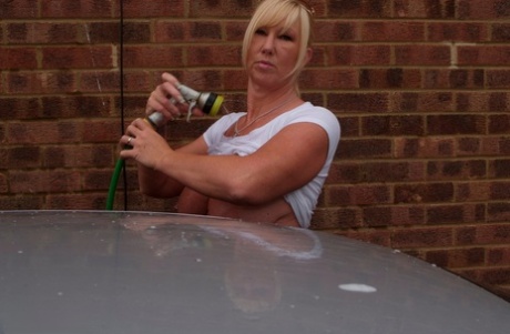 Melody, a big-tipped blonde amateur who wears a white T-shirt with a lot of glitter, is washing her car.